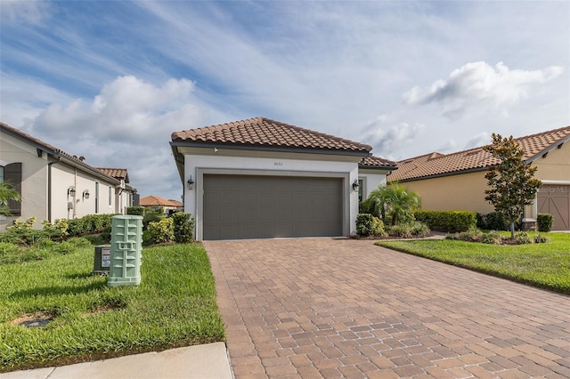 3051 Francoa Dr, Odessa, FL 33556 - mediterranean / spanish-style house featuring decorative driveway, a garage, stucco siding, and a tile roof