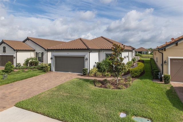 3051 Francoa Dr, Odessa, FL 33556 - mediterranean / spanish house with decorative driveway, a tile roof, stucco siding, a garage, and a front yard