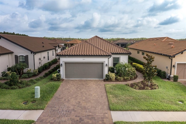 3051 Francoa Dr, Odessa, FL 33556 - mediterranean / spanish house with a garage, a front yard, decorative driveway, and stucco siding