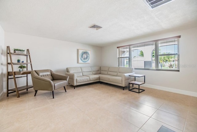 4468 Rudder Way, New Port Richey, FL 34652 - living room featuring baseboards, light tile patterned floors, and a textured ceiling