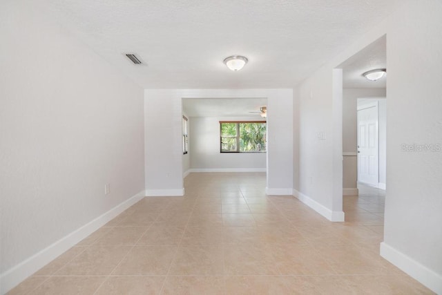 4468 Rudder Way, New Port Richey, FL 34652 - spare room featuring light tile patterned flooring, a textured ceiling, and baseboards