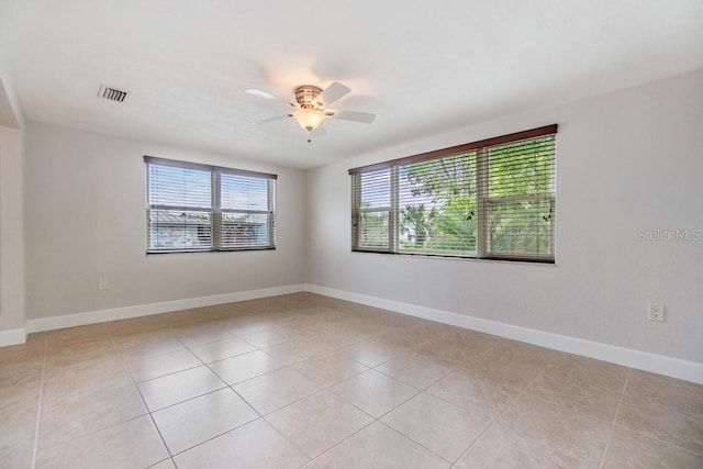4468 Rudder Way, New Port Richey, FL 34652 - empty room featuring plenty of natural light, ceiling fan, light tile patterned floors, and baseboards