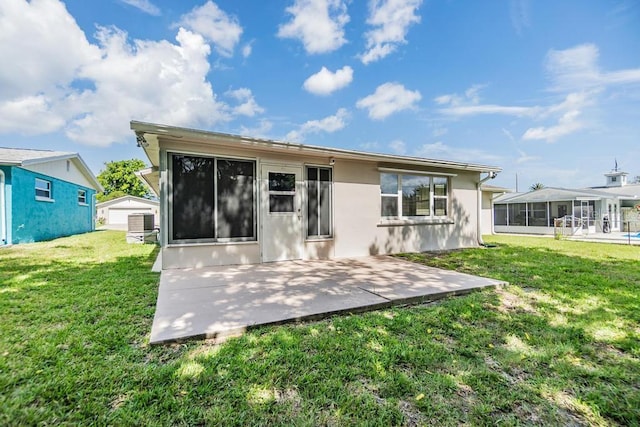 4468 Rudder Way, New Port Richey, FL 34652 - rear view of house with a patio, a lawn, a sunroom, stucco siding, and central air condition unit