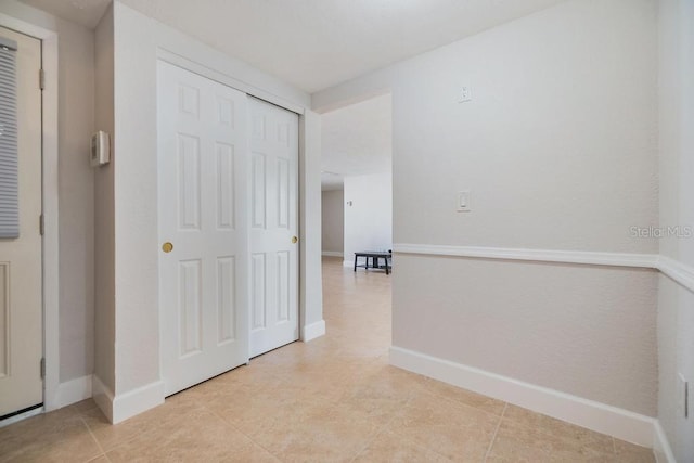 4468 Rudder Way, New Port Richey, FL 34652 - corridor featuring baseboards and light tile patterned flooring