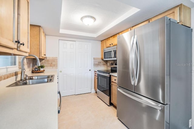 4468 Rudder Way, New Port Richey, FL 34652 - kitchen with appliances with stainless steel finishes, a sink, a tray ceiling, backsplash, and light countertops