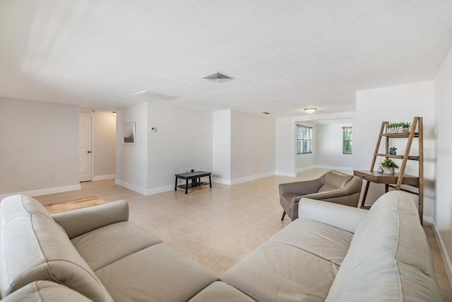 4468 Rudder Way, New Port Richey, FL 34652 - living room with a textured ceiling, baseboards, and light tile patterned floors
