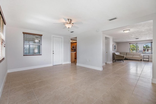 4468 Rudder Way, New Port Richey, FL 34652 - living room with ceiling fan, light tile patterned floors, and baseboards