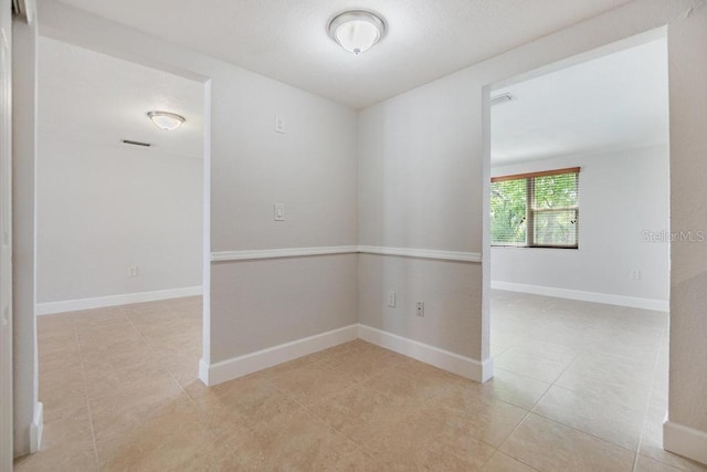 4468 Rudder Way, New Port Richey, FL 34652 - empty room featuring light tile patterned floors and baseboards