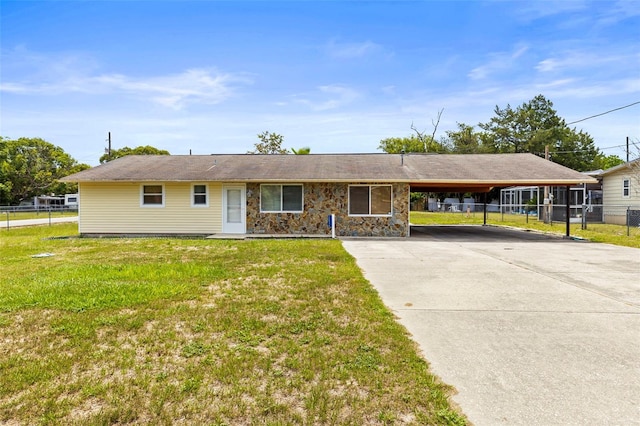 12936 Parkwood St, Hudson, FL 34669 - view of front facade featuring driveway, an attached carport, and stone siding