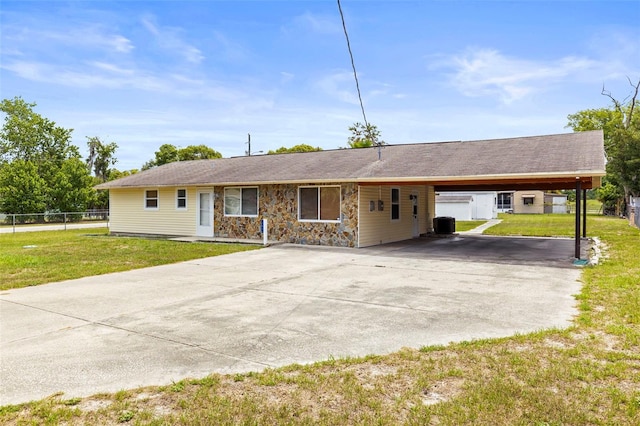 12936 Parkwood St, Hudson, FL 34669 - ranch-style home with concrete driveway, an attached carport, and stone siding