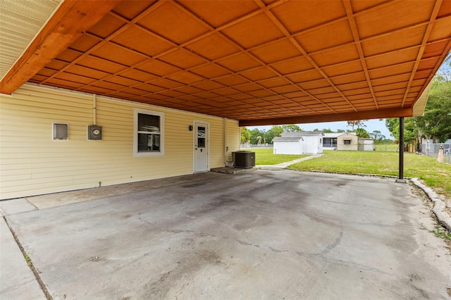12936 Parkwood St, Hudson, FL 34669 - view of patio / terrace with an attached carport, central AC, and an outdoor structure