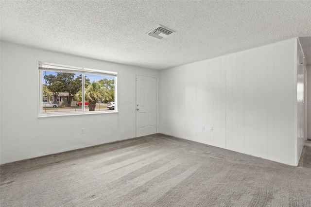 12936 Parkwood St, Hudson, FL 34669 - empty room featuring carpet flooring and a textured ceiling