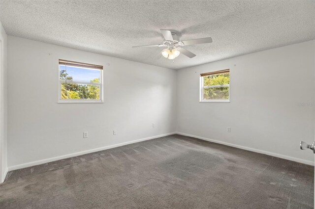 12936 Parkwood St, Hudson, FL 34669 - empty room featuring dark carpet, a ceiling fan, baseboards, and a textured ceiling