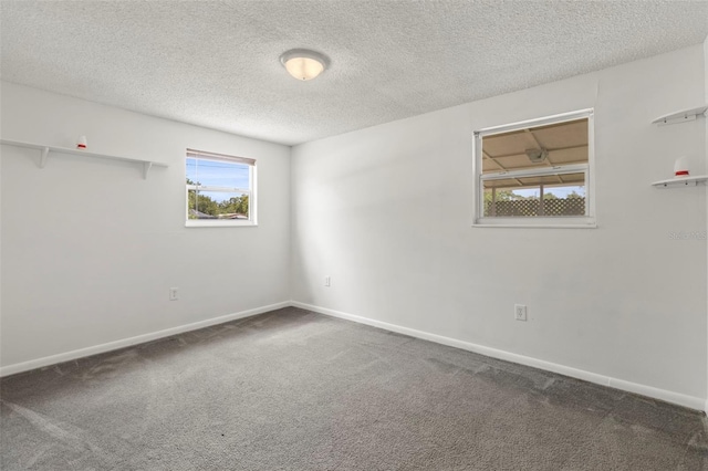 12936 Parkwood St, Hudson, FL 34669 - carpeted spare room featuring a textured ceiling and baseboards