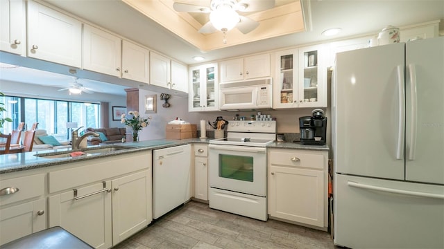 6620 Brambleleaf Dr, Spring Hill, FL 34606 - kitchen with white appliances, a sink, a ceiling fan, white cabinetry, and light wood finished floors