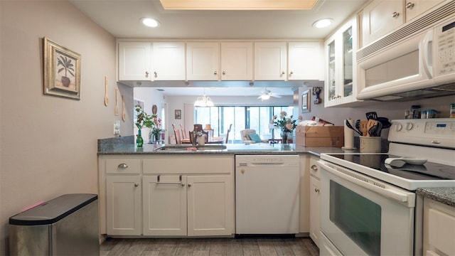 6620 Brambleleaf Dr, Spring Hill, FL 34606 - kitchen featuring white appliances, a sink, light wood-style flooring, white cabinetry, and recessed lighting