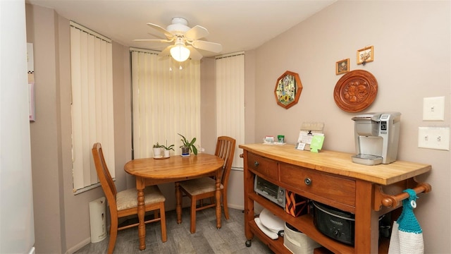6620 Brambleleaf Dr, Spring Hill, FL 34606 - dining room with a ceiling fan, wood finished floors, and baseboards