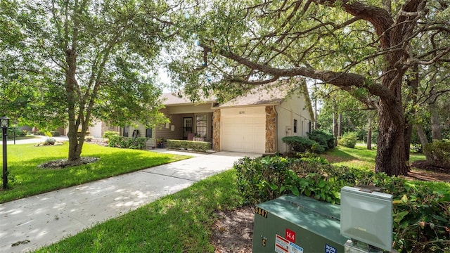 6620 Brambleleaf Dr, Spring Hill, FL 34606 - view of front facade with an attached garage, stone siding, driveway, and a front lawn
