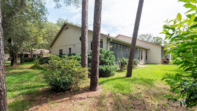 6620 Brambleleaf Dr, Spring Hill, FL 34606 - view of side of property featuring stucco siding and a lawn