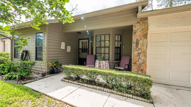 6620 Brambleleaf Dr, Spring Hill, FL 34606 - property entrance featuring an attached garage and stone siding