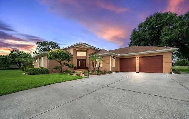 10044 Twelve Oaks Ct, Weeki Wachee, FL 34613 - ranch-style house featuring an attached garage, driveway, and a lawn