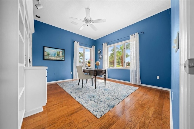 10044 Twelve Oaks Ct, Weeki Wachee, FL 34613 - office area featuring ceiling fan, wood finished floors, and baseboards