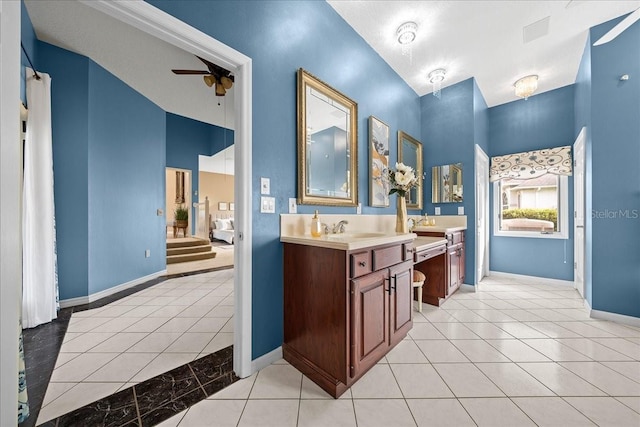 10044 Twelve Oaks Ct, Weeki Wachee, FL 34613 - full bath featuring double vanity, a ceiling fan, baseboards, and tile patterned floors