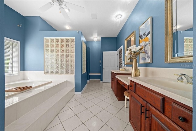 10044 Twelve Oaks Ct, Weeki Wachee, FL 34613 - full bath featuring a garden tub, two vanities, ceiling fan, and tile patterned flooring