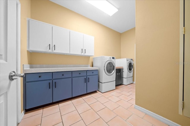10044 Twelve Oaks Ct, Weeki Wachee, FL 34613 - laundry area featuring washer and dryer, cabinet space, baseboards, and light tile patterned floors