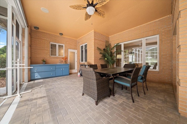 10044 Twelve Oaks Ct, Weeki Wachee, FL 34613 - view of patio with outdoor dining area, a ceiling fan, and a sink