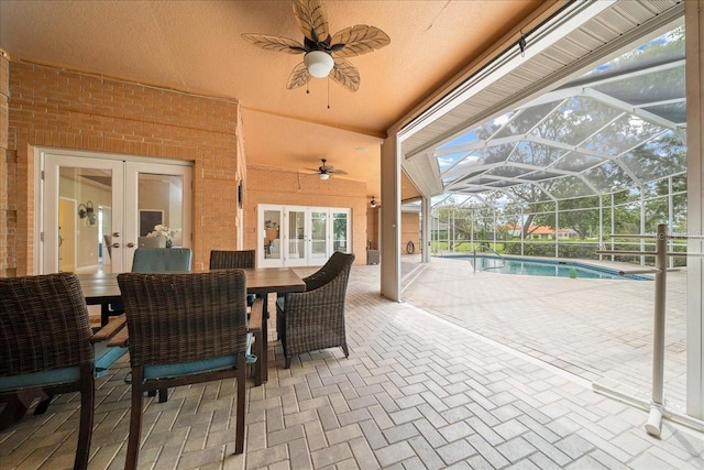 10044 Twelve Oaks Ct, Weeki Wachee, FL 34613 - view of patio / terrace with french doors, ceiling fan, an outdoor pool, a lanai, and outdoor dining area