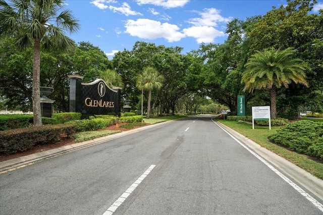10044 Twelve Oaks Ct, Weeki Wachee, FL 34613 - view of asphalt road with curbs and view of wooded area