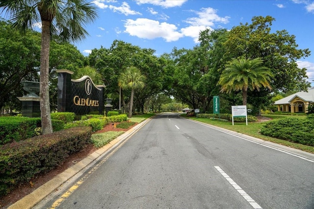10044 Twelve Oaks Ct, Weeki Wachee, FL 34613 - view of asphalt road with view of wooded area and curbs