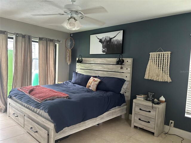 13316 Brigham Ln, Hudson, FL 34667 - bedroom with light tile patterned floors, ceiling fan, and baseboards