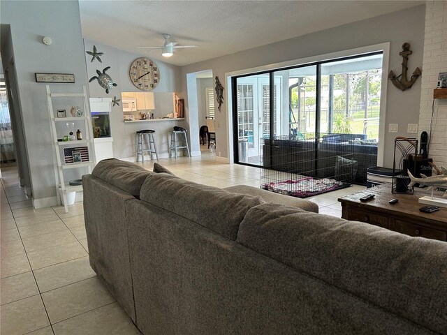 13316 Brigham Ln, Hudson, FL 34667 - living area featuring light tile patterned flooring, ceiling fan, lofted ceiling, and baseboards