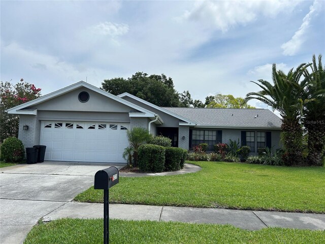 13316 Brigham Ln, Hudson, FL 34667 - ranch-style home with brick siding, a garage, a front lawn, and driveway