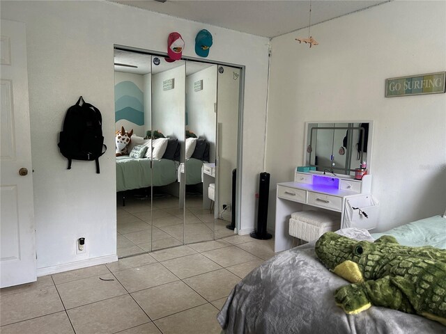 13316 Brigham Ln, Hudson, FL 34667 - bedroom featuring light tile patterned flooring and a closet
