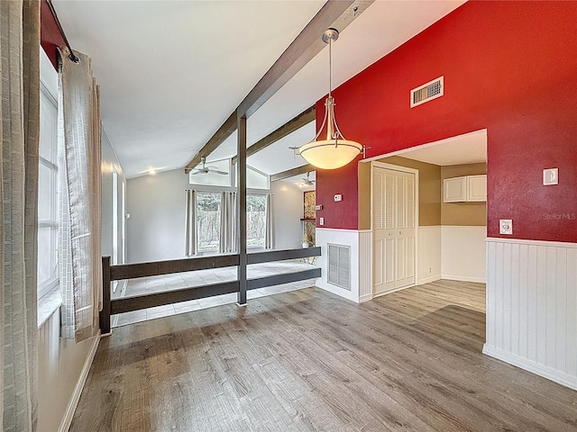 7119 Lenape Cir, New Port Richey, FL 34653 - unfurnished living room featuring wood finished floors and wainscoting