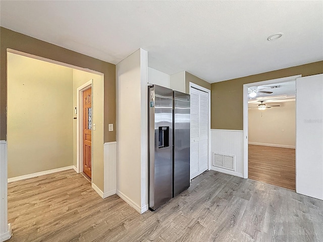 7119 Lenape Cir, New Port Richey, FL 34653 - kitchen with stainless steel fridge, wood finished floors, ceiling fan, and baseboards