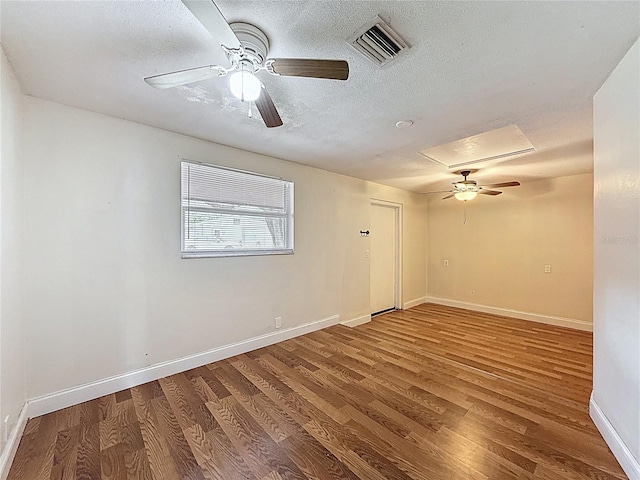 7119 Lenape Cir, New Port Richey, FL 34653 - empty room featuring ceiling fan, wood finished floors, baseboards, and a textured ceiling