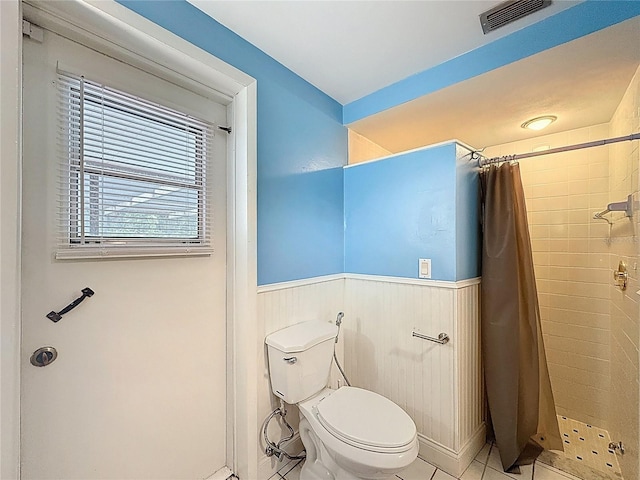 7119 Lenape Cir, New Port Richey, FL 34653 - full bathroom with a shower stall, toilet, wainscoting, and tile patterned floors