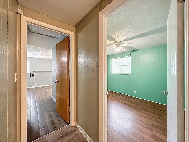 7119 Lenape Cir, New Port Richey, FL 34653 - corridor featuring wood finished floors, baseboards, and a textured ceiling
