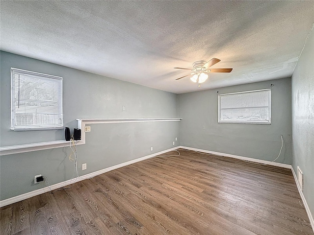 7119 Lenape Cir, New Port Richey, FL 34653 - spare room featuring wood finished floors, ceiling fan, a textured ceiling, and baseboards