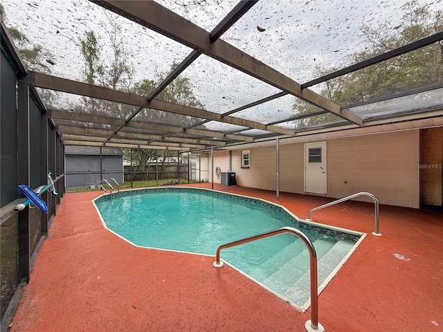 7119 Lenape Cir, New Port Richey, FL 34653 - outdoor pool with central AC unit, a patio, and glass enclosure