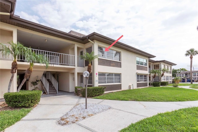 5123 Topaz Ln Unit 206, New Port Richey, FL 34652 - view of property featuring stairway and a carport