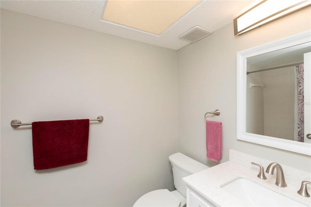 5123 Topaz Ln Unit 206, New Port Richey, FL 34652 - bathroom featuring toilet, vanity, and a shower with shower curtain