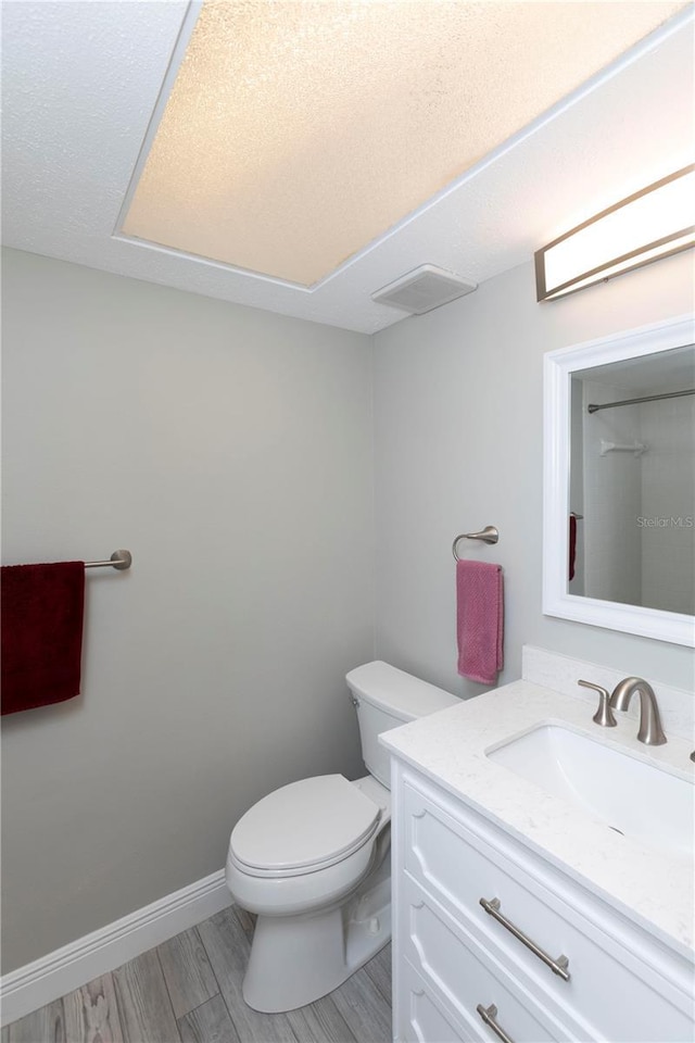 5123 Topaz Ln Unit 206, New Port Richey, FL 34652 - bathroom with vanity, toilet, and wood finished floors