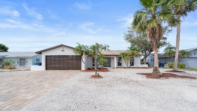 1024 Spindle Palm Way, Apollo Beach, FL 33572 - ranch-style home with a garage, stucco siding, and decorative driveway