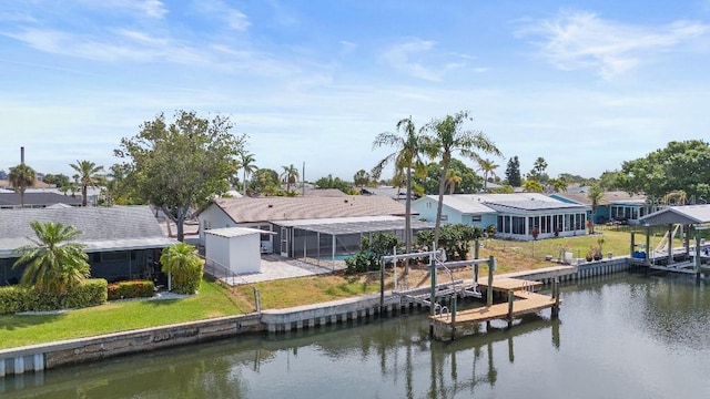1024 Spindle Palm Way, Apollo Beach, FL 33572 - back of property with a water view, a residential view, boat lift, and a lawn