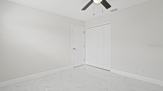 1024 Spindle Palm Way, Apollo Beach, FL 33572 - unfurnished bedroom featuring light marble finish floors, baseboards, a closet, and ceiling fan